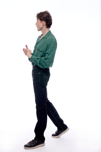 Side view of Model 1 wearing the Greatest Swordsman black+green jeans (X is visible)